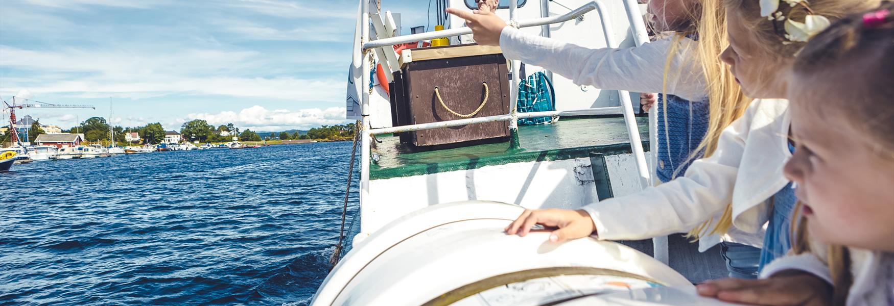 girls on a boat looking out over the water