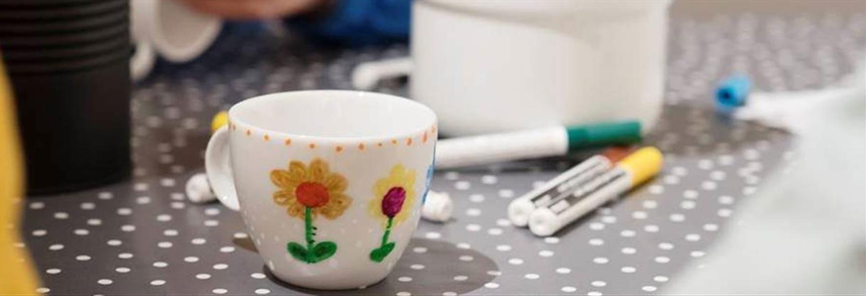 cup and colored pencils