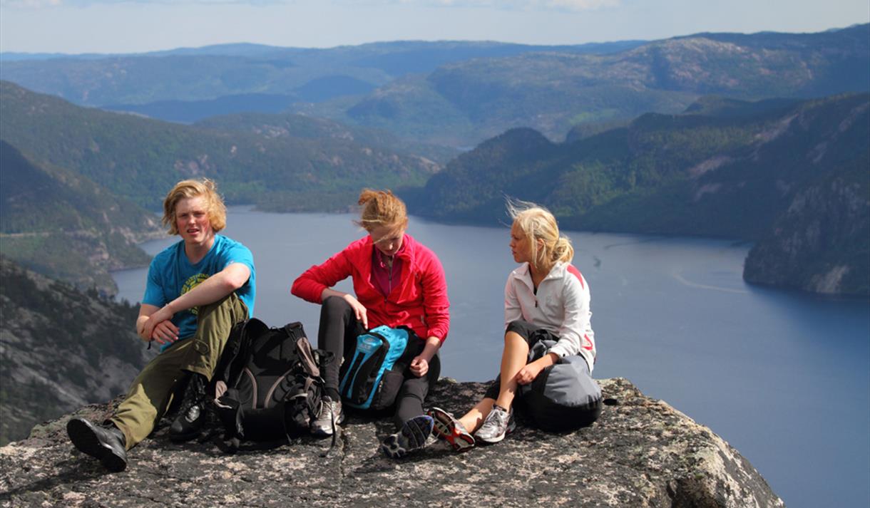 group of 3 sitting on a peak