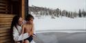 girl with boy on a floating sauna at Gausta in winter