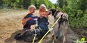 2 girls pet the dogs from Telemark Husky Tours
