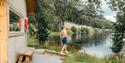 Man takes a bath in Hjartsjå, right next to Saga Sauna.
