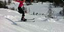 Nice jumping, girl on telemarkskis