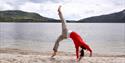 girl doing yoga on the beach