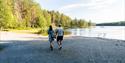 couple walks along the sandy beach at Tinnemyra