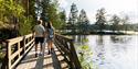 couple walks across a bridge at Tinnemyra