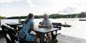 couple sits on a bench at a rest area along the hiking trail around Tinnemyra