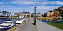 Langbrygga in Skien with a playground and recreational boats with the city center in the background