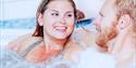 man and woman relax in a jacuzzi at the Spa and wellness department in Skien leisure park