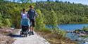 couple with pram walks on a walk at Vasseventyret