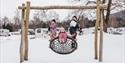 children on the playground at Beverøya Cabin Rental and Camping in winter
